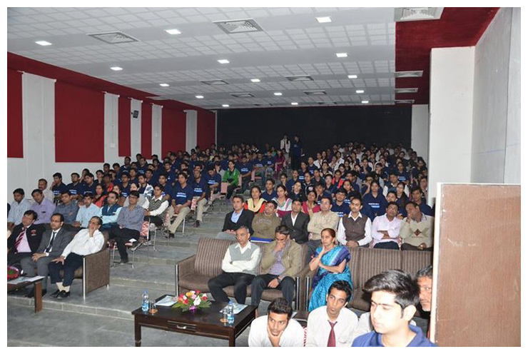 A speaker addressing students in a seminar hall